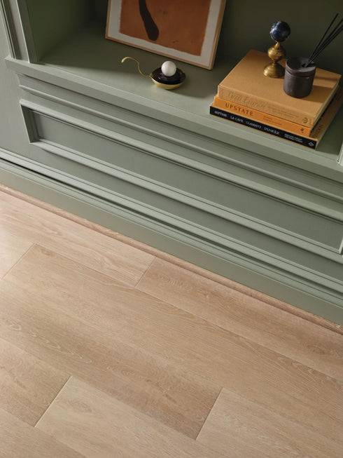 COREtec Originals Premium Wheat Oak flooring with quarter round transition piece.